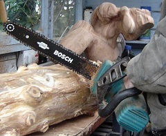 Slice into the log with a chainsaw